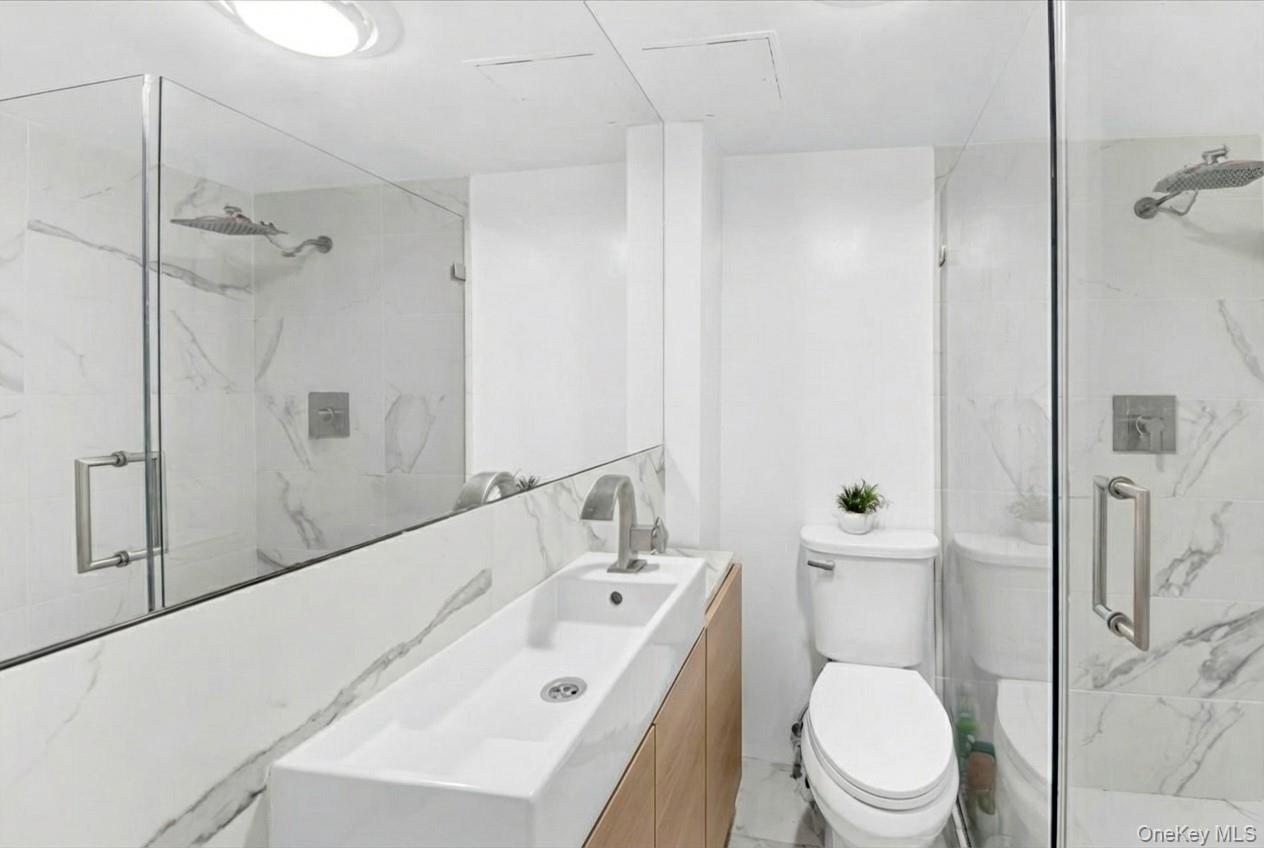1456 Boston Post Road, Unit K2 Larchmont, NY 10538 - Photo 17 of 27 a bathroom with a sink a toilet and shower