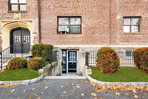 a view of a house with a garden and plants