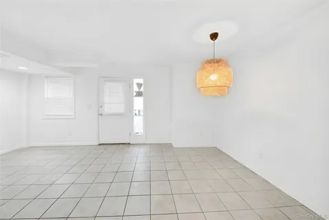 an empty room with kitchen view