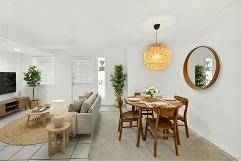 a view of a dining room with furniture and a chandelier
