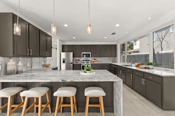 a kitchen with granite countertop lots of counter top space and appliances