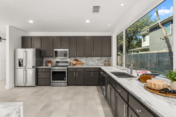a kitchen with a sink stove and refrigerator