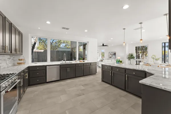 a large kitchen with stainless steel appliances lots of counter top space