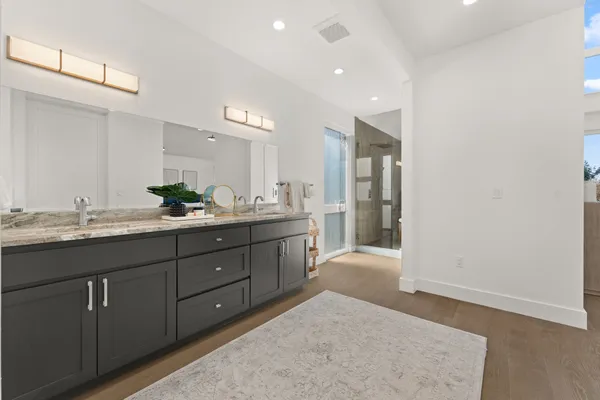 a bathroom with a granite countertop sink and a mirror