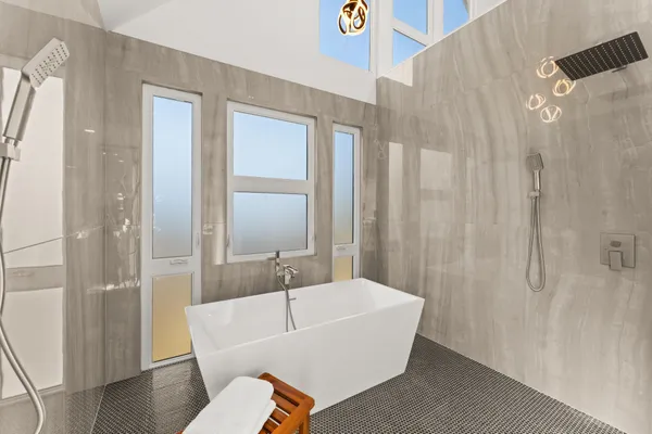 a white bath tub sitting next to a white toilet