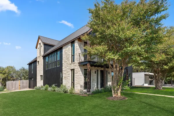 a front view of house with a garden