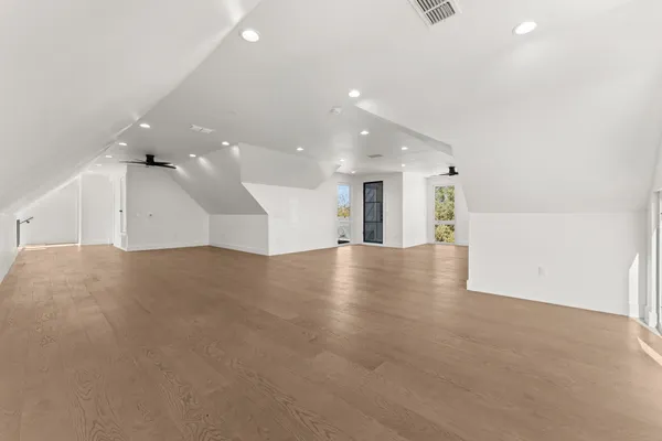 an empty room with a kitchen and a window