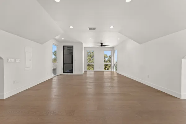 an empty room with windows and entrance