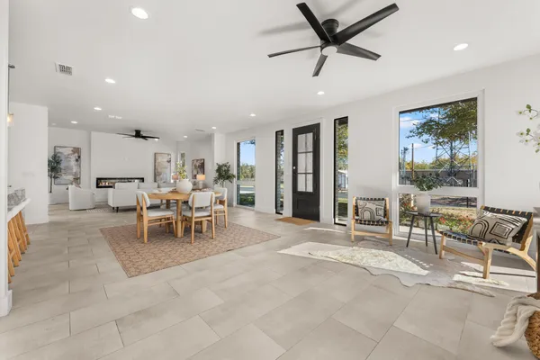 a living room with furniture and kitchen view