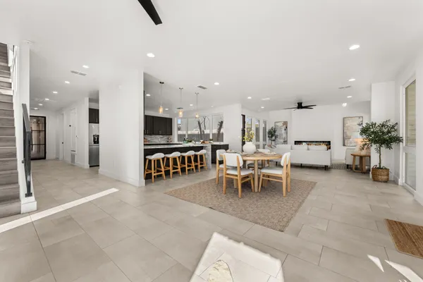 a large dining space with furniture and a view of living room