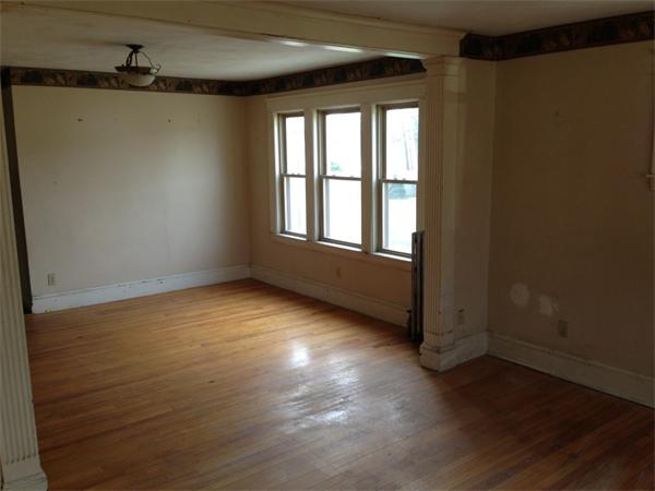4 Assumption Avenue Worcester, MA 01606 - Photo 7 of 13 an empty room with wooden floor and windows