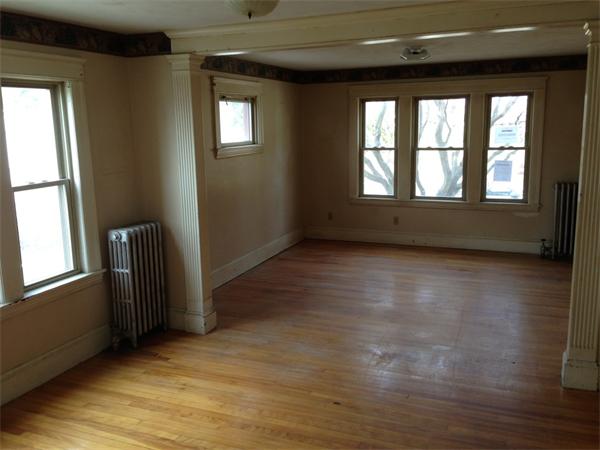 4 Assumption Avenue Worcester, MA 01606 - Photo 8 of 13 an empty room with wooden floor and windows