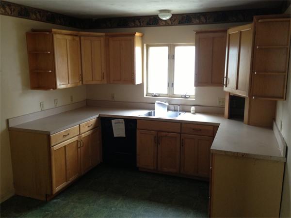 4 Assumption Avenue Worcester, MA 01606 - Photo 9 of 13 a kitchen with a sink stove and cabinets