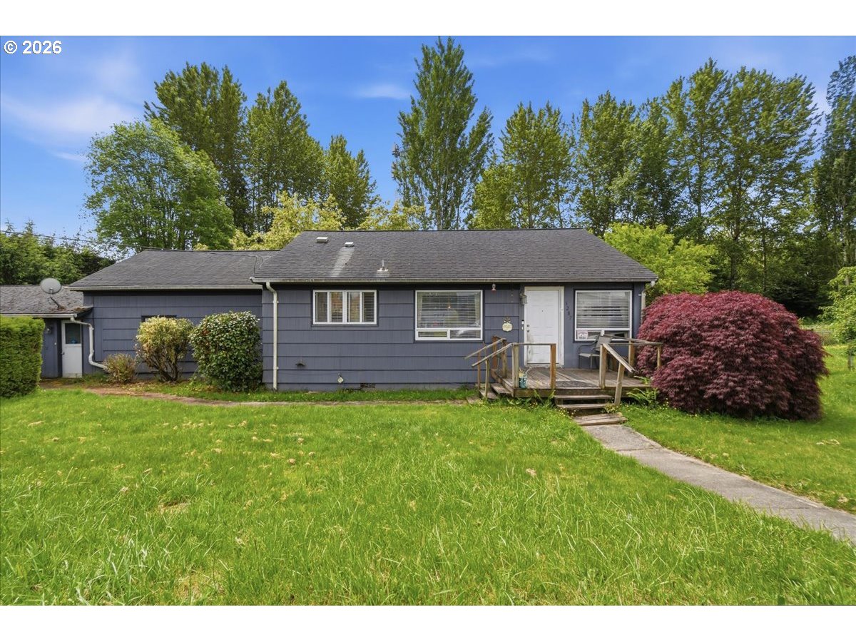 3287 Olive Way Longview, WA 98632 - Photo 2 of 24 a front view of a house with a garden