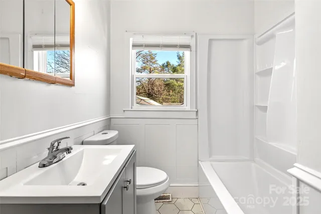 a bathroom with a sink toilet and tub