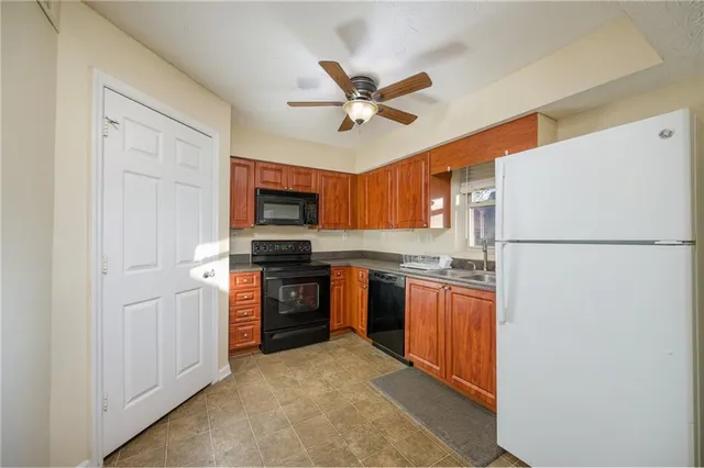 a kitchen with stainless steel appliances granite countertop a refrigerator stove and sink