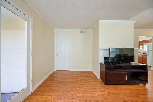 a kitchen with a refrigerator and a stove top oven