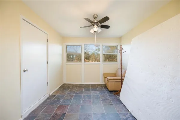 a view of a room with a window and hardwood floor