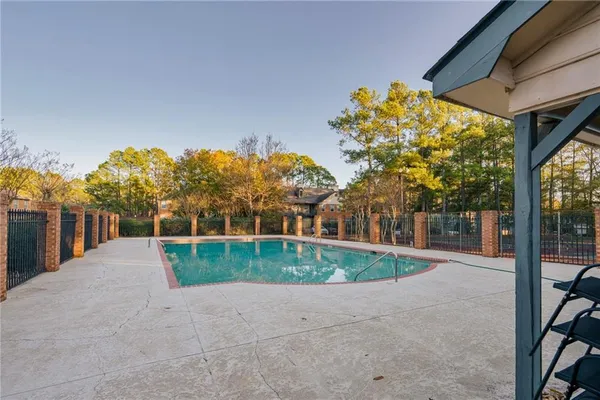 a view of a house with a yard and potted plants