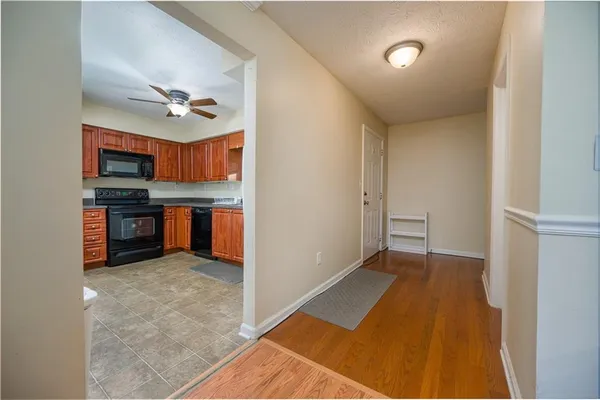 a view of a kitchen with a sink and a refrigerator