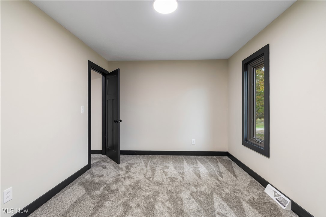 2201 Ridgewood Road Medina, OH 44256 - Photo 32 of 50 Empty room featuring light carpet and baseboards