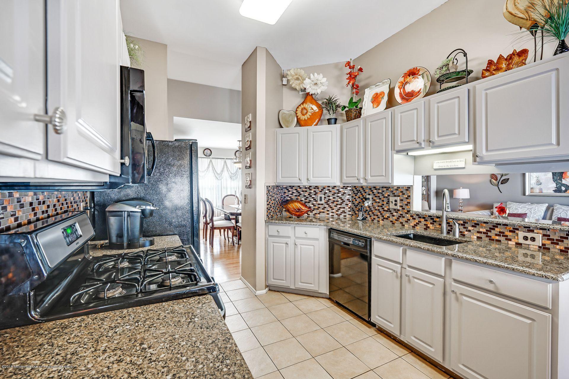 136 Cruise Road Manahawkin, NJ 08050 - Photo 12 of 34 a kitchen with stainless steel appliances granite countertop a stove a sink and a refrigerator