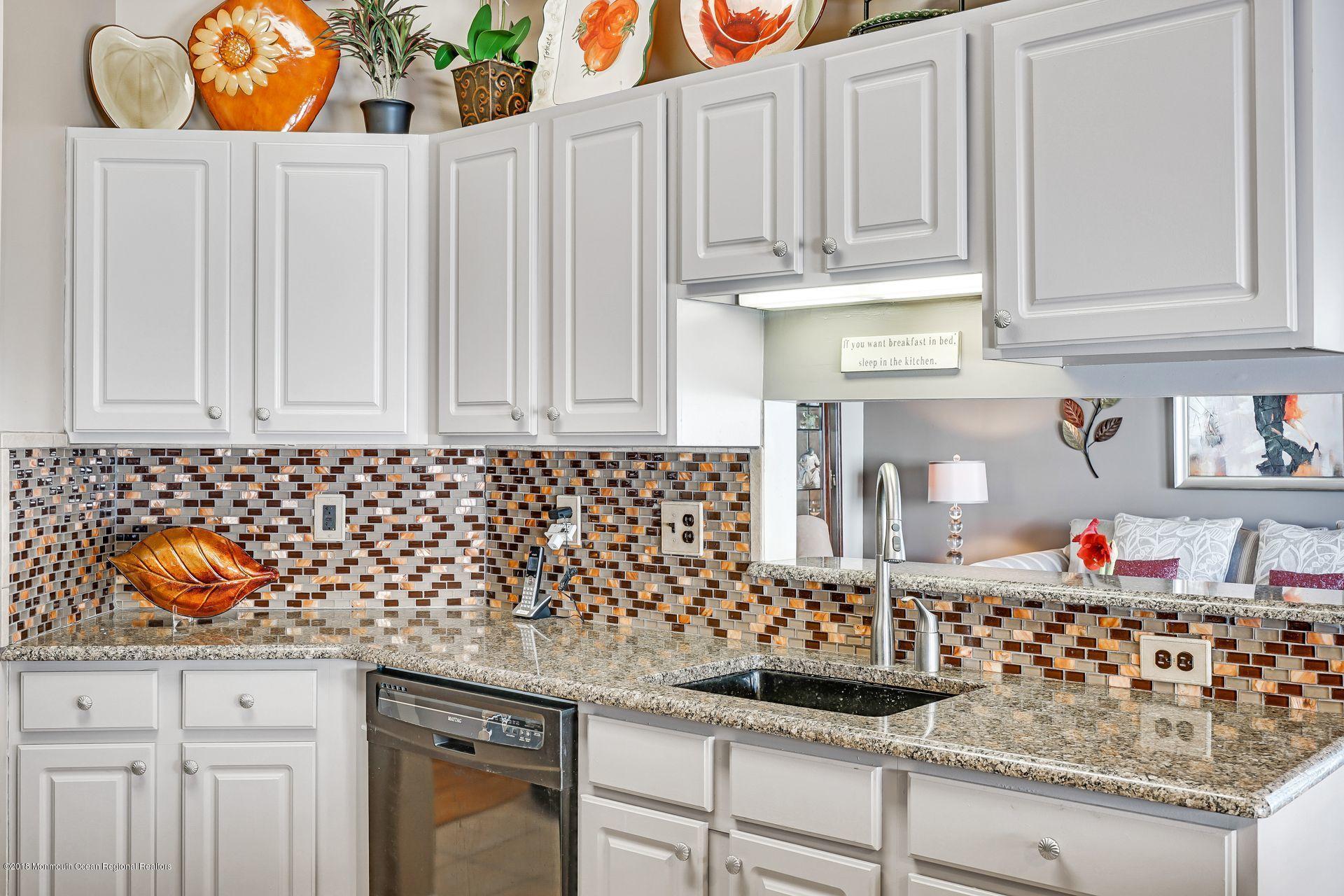 136 Cruise Road Manahawkin, NJ 08050 - Photo 13 of 34 a kitchen with granite countertop white cabinets and sink