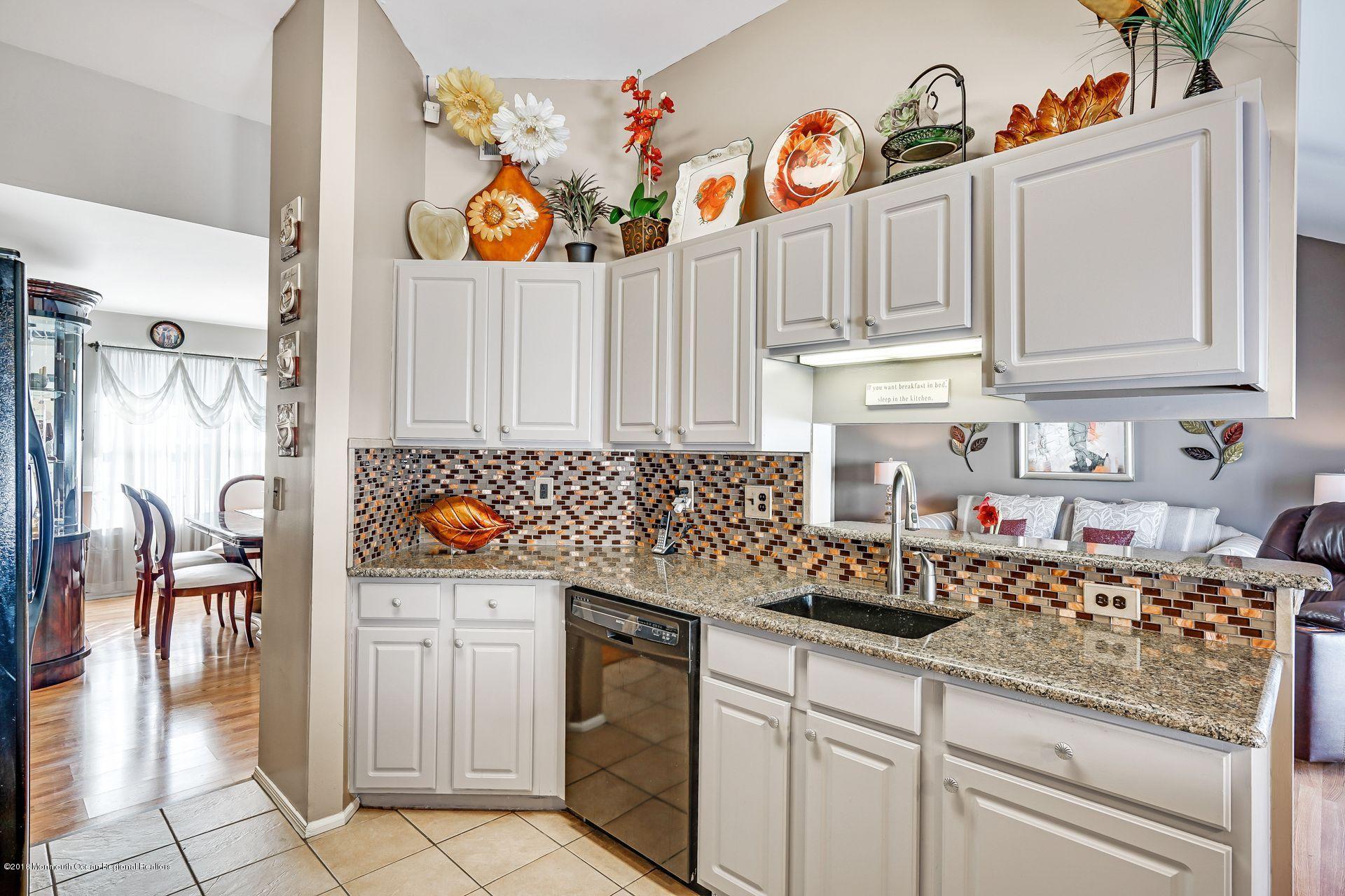 136 Cruise Road Manahawkin, NJ 08050 - Photo 16 of 34 a kitchen with stainless steel appliances granite countertop a sink and cabinets