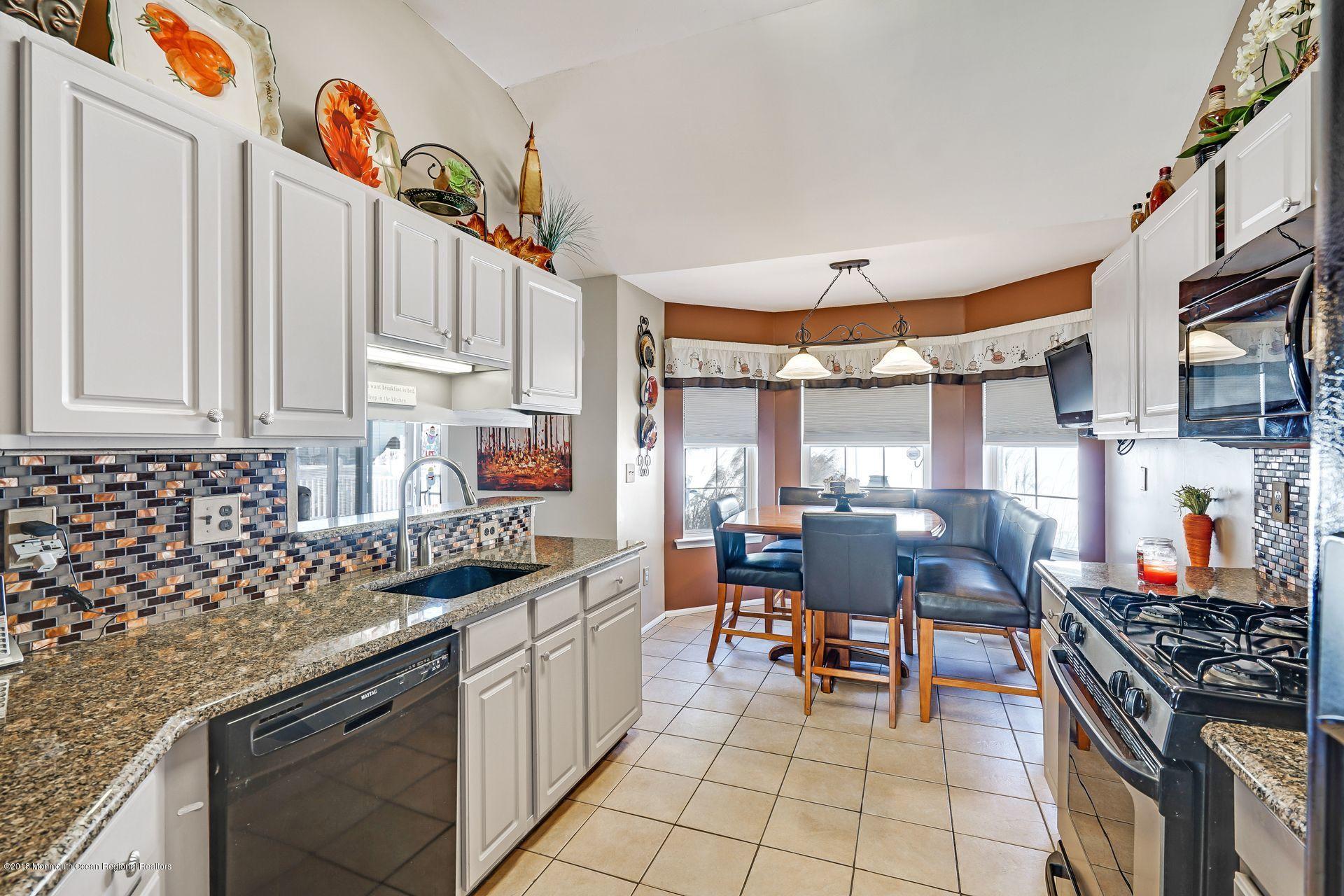 136 Cruise Road Manahawkin, NJ 08050 - Photo 19 of 34 a kitchen with stainless steel appliances granite countertop a stove a sink and a refrigerator