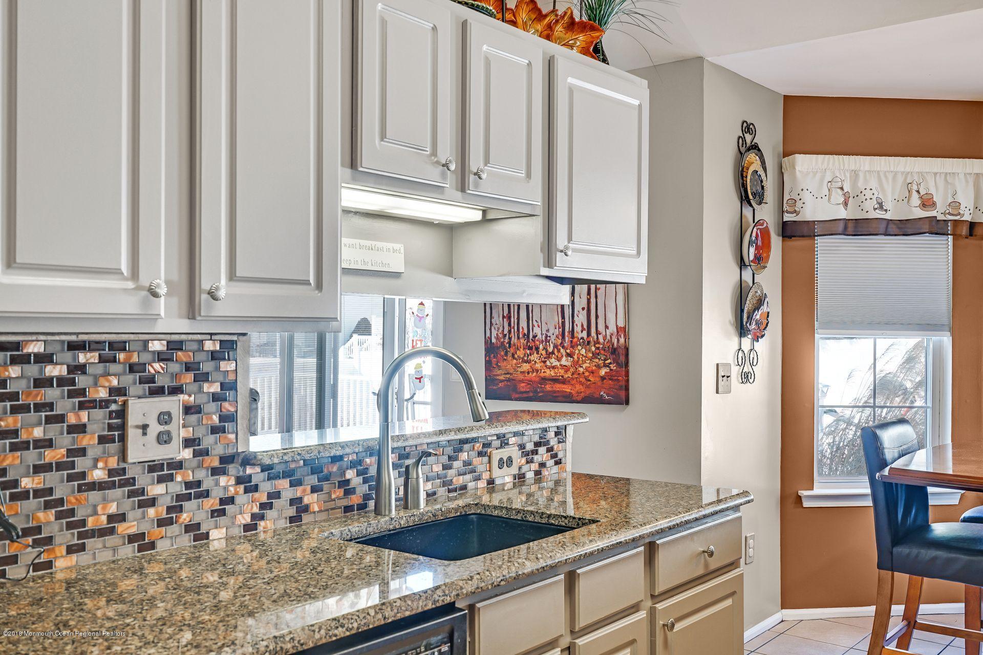 136 Cruise Road Manahawkin, NJ 08050 - Photo 20 of 34 a kitchen with granite countertop a sink and a stove top oven
