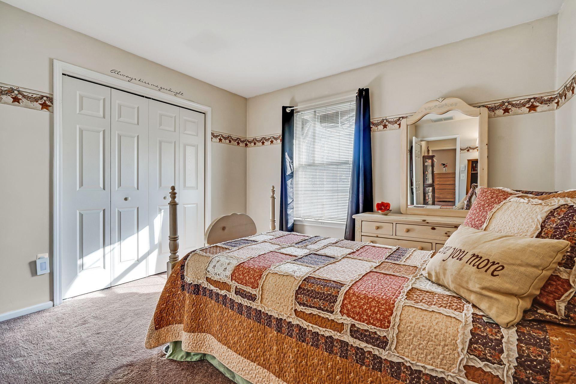 136 Cruise Road Manahawkin, NJ 08050 - Photo 23 of 34 a bedroom with a bed and a mirror