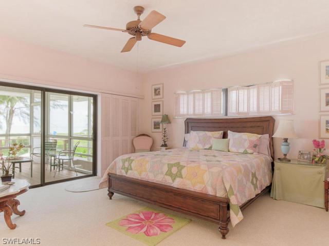 4627 Rue Belle Mer Sanibel, FL 33957 - Photo 13 of 25 a bedroom with a bed a chandelier and a window