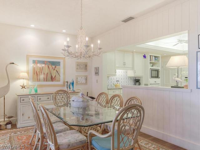 4627 Rue Belle Mer Sanibel, FL 33957 - Photo 16 of 25 a view of a dining room with furniture window and wooden floor