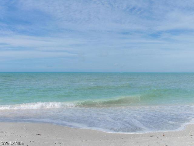 4627 Rue Belle Mer Sanibel, FL 33957 - Photo 22 of 25 a view of a big yard with beach and fence