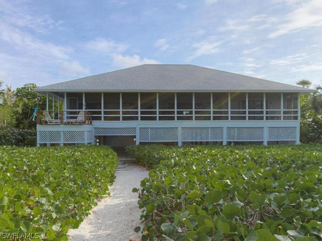 4627 Rue Belle Mer Sanibel, FL 33957 - Photo 24 of 25 a front view of a house with a garden