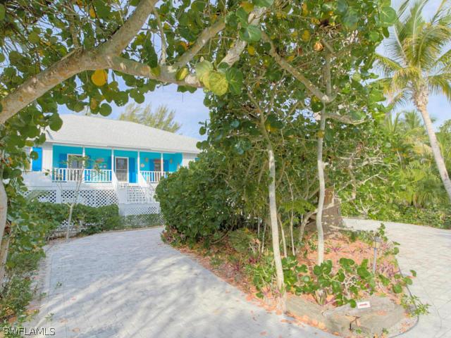 4627 Rue Belle Mer Sanibel, FL 33957 - Photo 5 of 25 a front view of a house with a yard