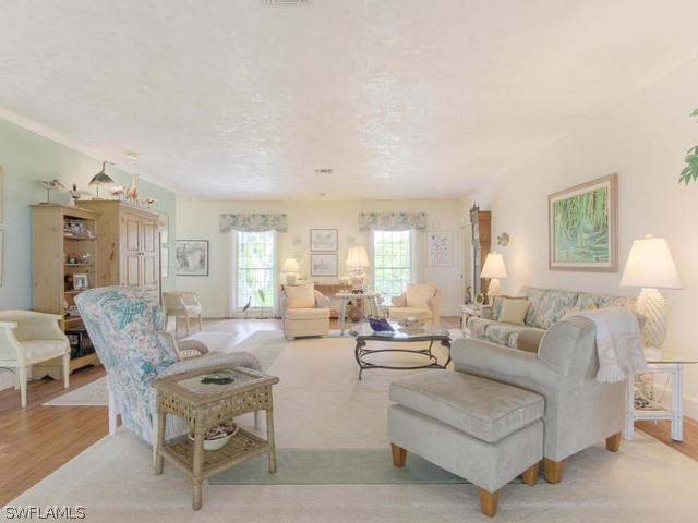 4627 Rue Belle Mer Sanibel, FL 33957 - Photo 8 of 25 a living room with furniture and a large window