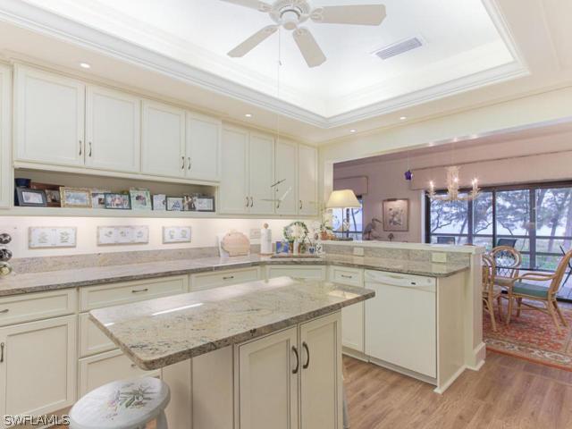 4627 Rue Belle Mer Sanibel, FL 33957 - Photo 9 of 25 a kitchen with a sink a stove and cabinets