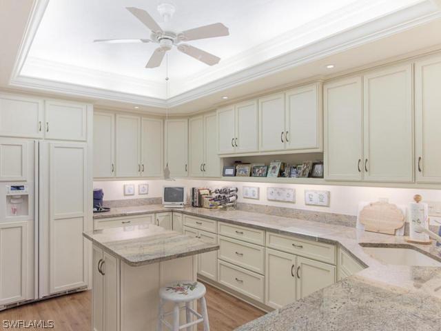 4627 Rue Belle Mer Sanibel, FL 33957 - Photo 10 of 25 a kitchen with granite countertop a sink a stove and cabinets