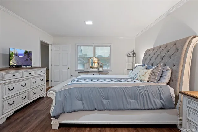 a bedroom with a bed and dresser