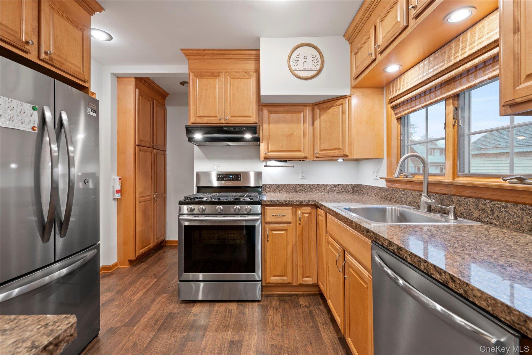 51 Marvin Street Patchogue, NY 11772 - Photo 6 of 25 a kitchen with stainless steel appliances granite countertop a stove a refrigerator and a sink