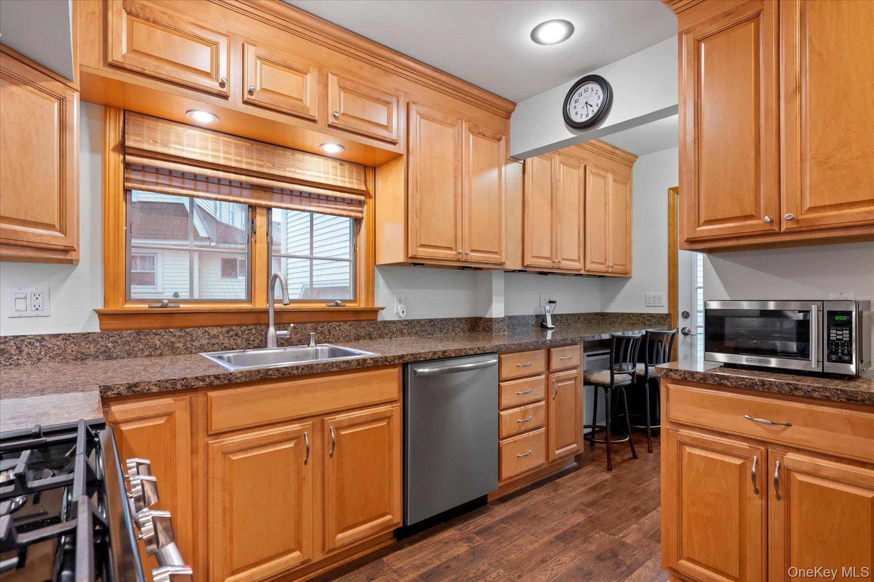 51 Marvin Street Patchogue, NY 11772 - Photo 7 of 25 a kitchen with granite countertop stainless steel appliances a stove sink and microwave