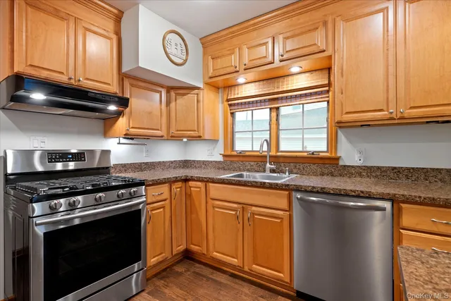 a kitchen with stainless steel appliances granite countertop a stove and a microwave