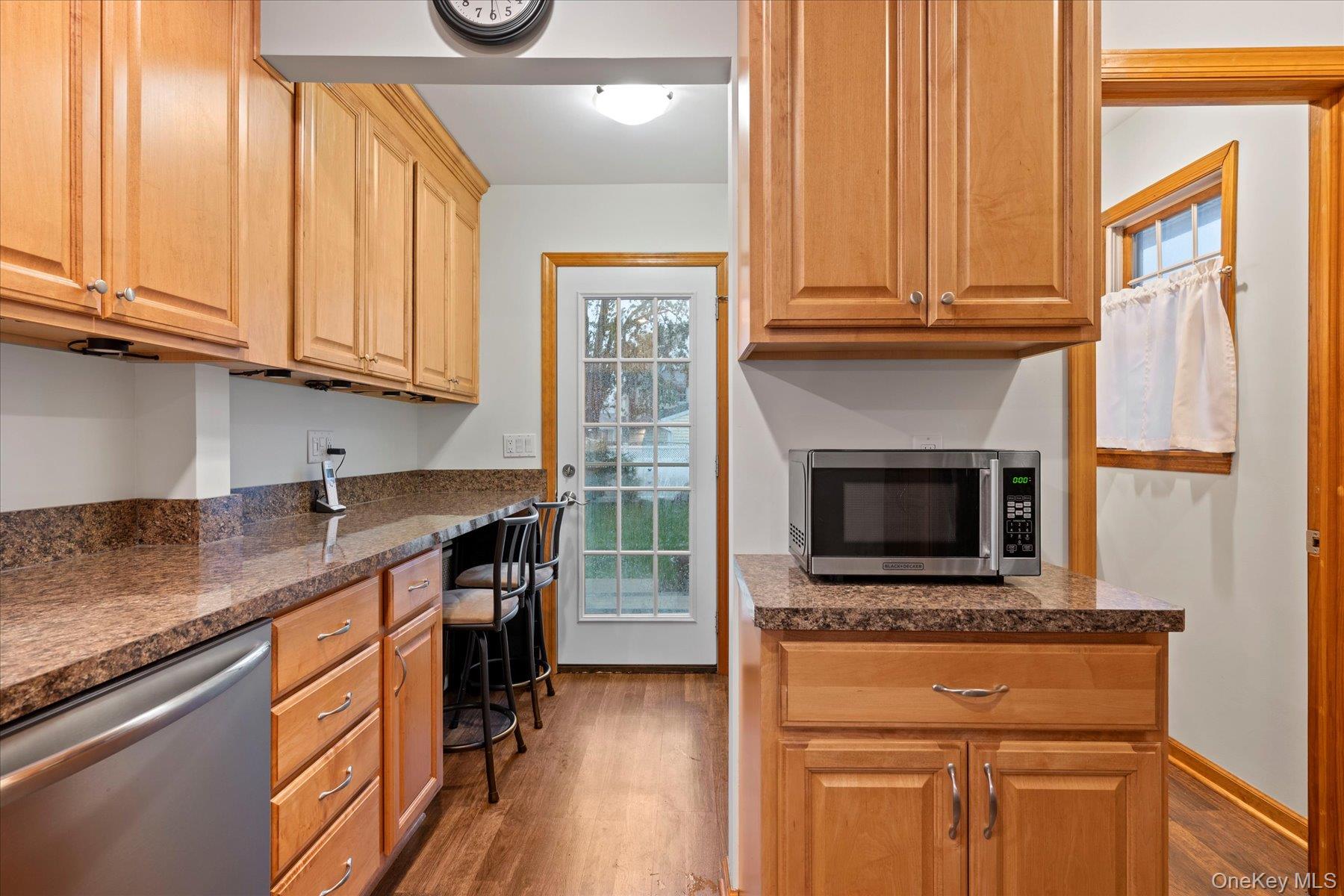 51 Marvin Street Patchogue, NY 11772 - Photo 9 of 25 a kitchen with stainless steel appliances granite countertop a stove a sink and a microwave
