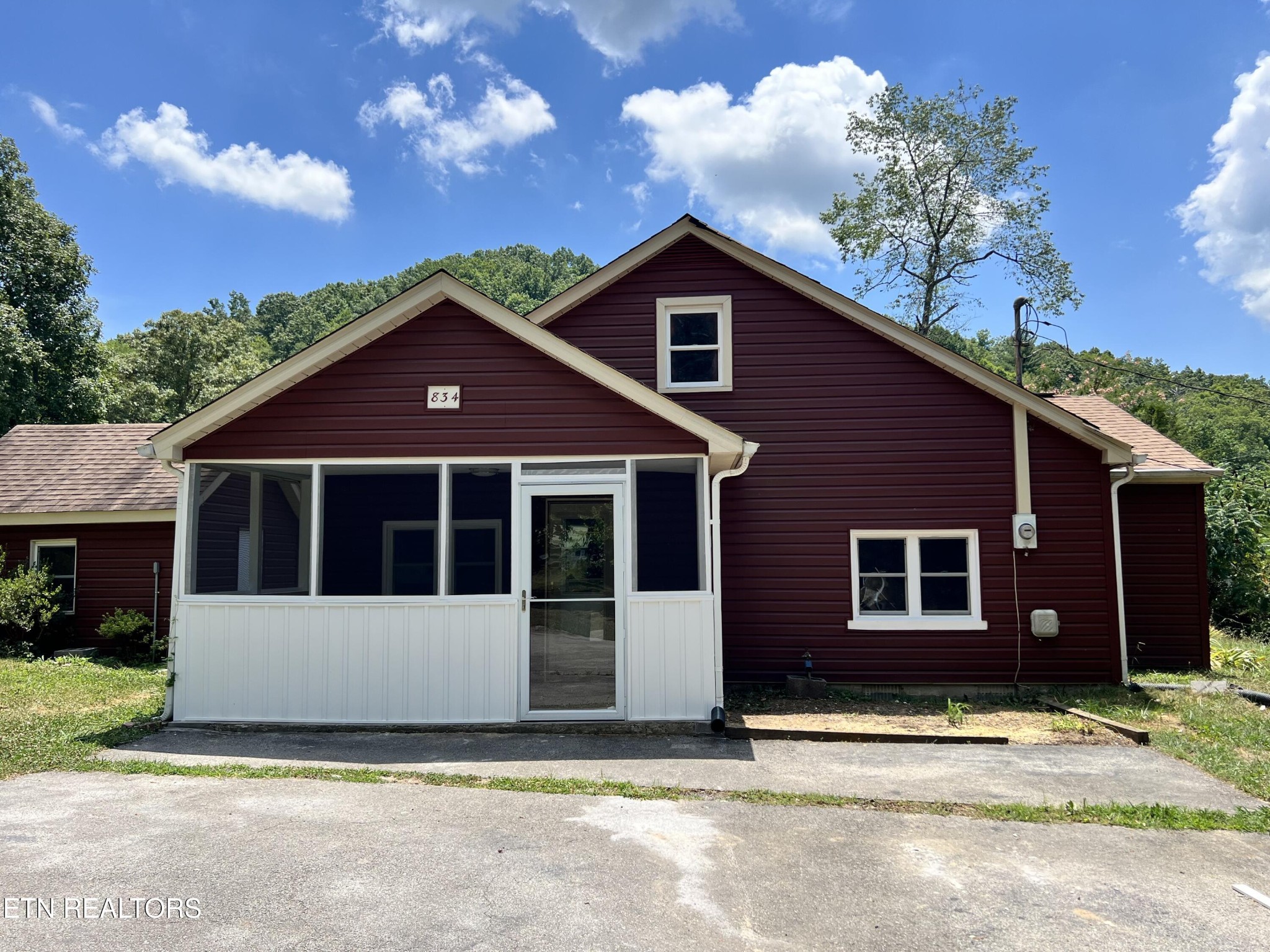 834 Cemetery Road Oliver Springs, TN 37840 - Photo 1 of 16 a front view of a house with a garden