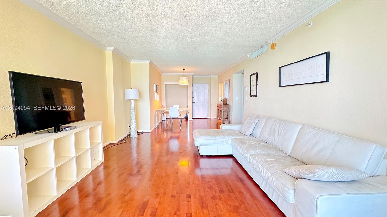 2501 South Ocean Drive, Unit 820 Hollywood, FL 33019 - Photo 2 of 12 a living room with furniture and a flat screen tv