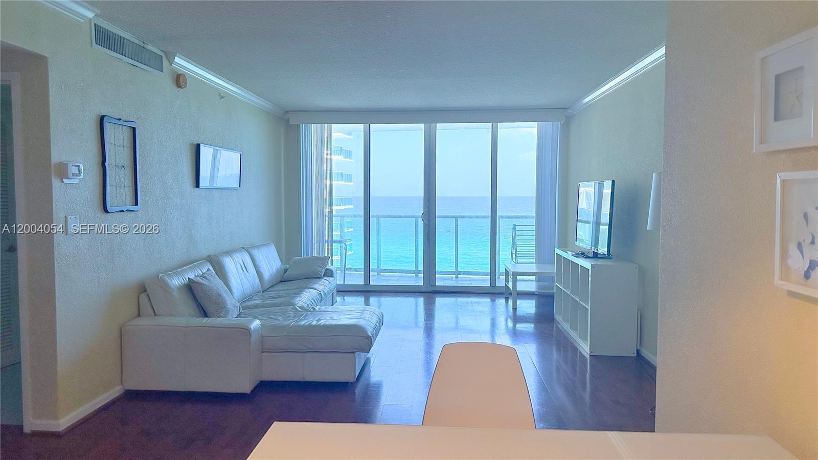 2501 South Ocean Drive, Unit 820 Hollywood, FL 33019 - Photo 10 of 12 a living room with furniture and a floor to ceiling window