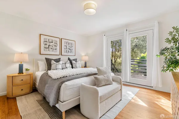a bedroom with a bed and a potted plant