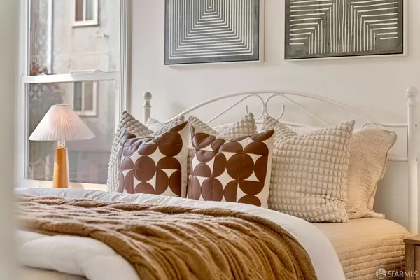 a bedroom with bed and cabinets