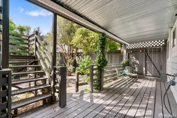 an aerial view of a house with outdoor seating